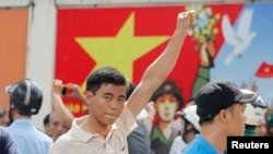 A protester gestures as he marches during an anti-China protest in Vietnam's southern Ho Chi Minh city, May 18, 2014. 