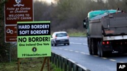 A poster against a hard border stands on the border between Northern Ireland and the Republic of Ireland near the town of Derrylin, Northern Ireland, Dec. 12, 2018. 