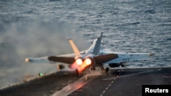 FILE - An EA-18G Growler launches from the Nimitz-class aircraft carrier USS Carl Vinson (CVN 70) in this U.S. Navy picture taken in the Arabian Gulf, October 28, 2014.