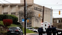 FILE - First responders stand outside the Tree of Life Synagogue in Pittsburgh, Oct. 27, 2018. 