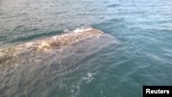 FILE - A piece of metal, presumably from doomed US rocket SpaceX Falcon, recovered from the sea off the Isles of Scilly in Britain, is seen in this handout provided to Reuters on Nov. 27, 2015. 