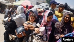 Palestinci, koji su pobjegli iz istočnog dijela Khan Younisa nakon što im je izraelska vojska naredila da evakuiraju svoje susjedstvo, voze se vozilom natovarenim stvarima, usred sukoba između Izraela i Hamasa, u Khan Younisu u južnom pojasu Gaze 2. jula 2024.