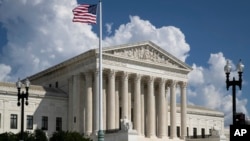 An American flag flies outside the Supreme Court in Washington, Sept. 3, 2018.