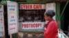 FILE - A pedestrian passes an internet cafe in the Kibera neighborhood of Nairobi, Kenya, Sept. 29, 2021. Internet outages in March and May 2024 disrupted business and communication in many African nations.