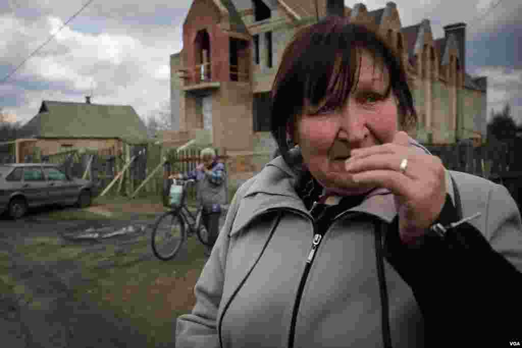 Local resident Lida cries outside Noah's Ark Church in the town of Krasnohorivka, saying, “in Kyiv they are far from reality, they cannot understand that war came to this town." (Adam Bailes/VOA)