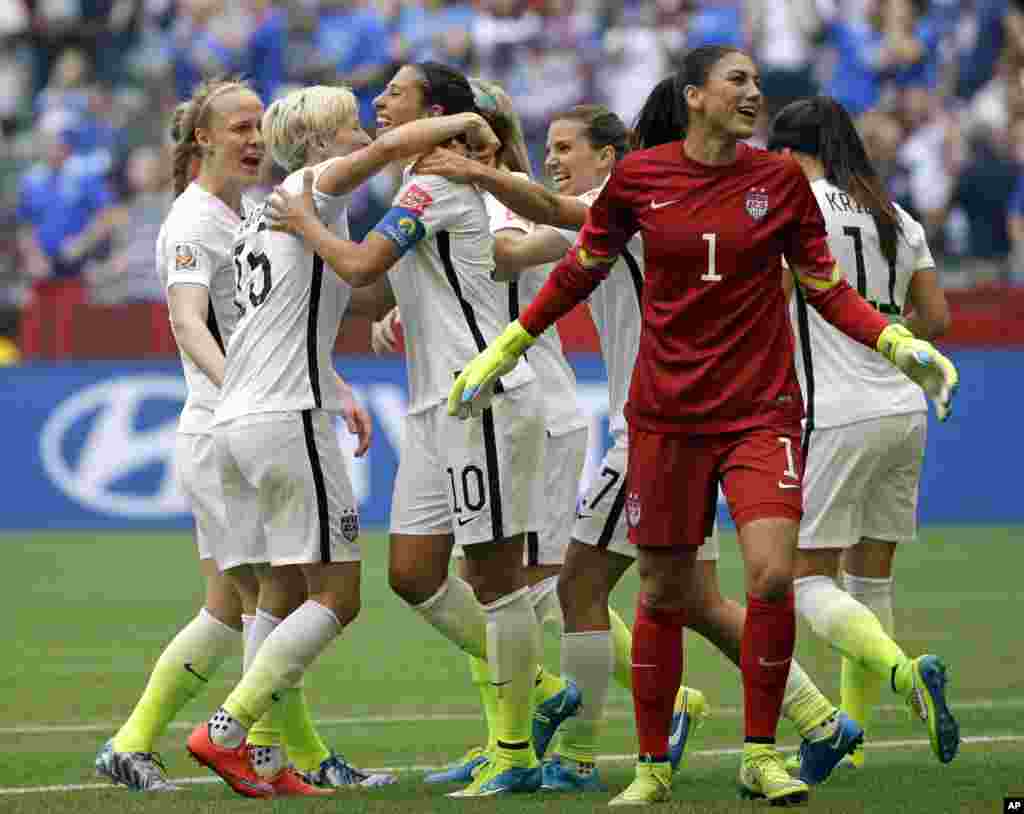 United States' Carli Lloyd (third from left) celebrates with teammates, including goalkeeper Hope Solo (1), after Lloyd scored her third goal against Japan during the first half of the Women's World Cup soccer championship in Vancouver, July 5, 2015.