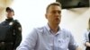 FILE - Russian opposition leader Alexei Navalny talks to journalists during a hearing at a court in Moscow, Russia, June 12, 2017. 