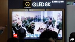На экране телевизора на железнодорожном вокзале Сеула - видео северокорейских военных, получающих снаряжение в России. 21 октября 2024 г. (Фото AP/Ан Ён Чжун).
