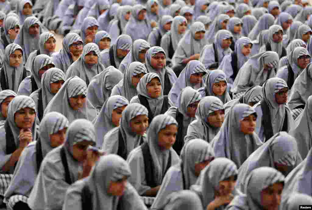 School girls listen to their teacher (not pictured) during a lecture on the Article 370, a special constitutional status for Kashmir which was scrapped by the Indian government last month, to mark Prime Minister Narendra Modi's birthday at a school in Ahmedabad, India.