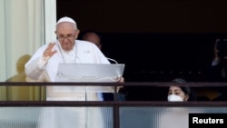 Pope Francis leads the Angelus prayer from a balcony of the Gemelli hospital, as he recovers following scheduled surgery on his colon, in Rome, Italy, July 11, 2021. 