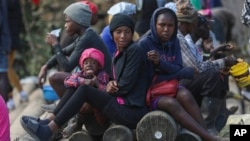 FILE - People displaced by armed gang attacks take refuge in the town hall of the Kenscoff neighborhood of Port-au-Prince, Haiti, Feb. 13, 2025.