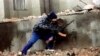 FILE - A Chechen fighter moves into position next to the Presidential Palace in central Grozny during heavy fighting, Jan. 10, 1995.