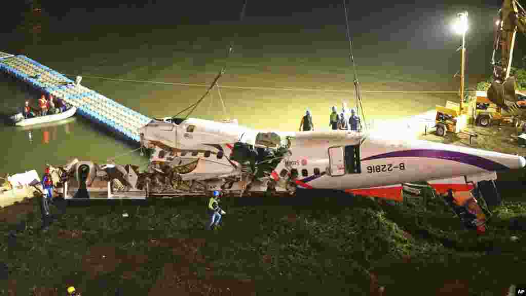 Le fuselage de l'avion commercial de TransAsia Airways est retiré de la rivière dans laquelle il s'est abimé mercredi après son décollage dans la ville de la nouvelle Taipei, Taiwan.