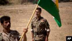 FILE - A commander instructs new recruits of the Democratic Party of Iranian Kurdistan during training at their base in Koya, northern Iraq, Sept. 21, 2016.