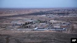FILE - An aerial photo taken from a helicopter shows al-Asad Air Base in the western Anbar desert, Iraq, Dec. 29, 2019. It was one of the sites where U.S. forces have been attacked with drones or rockets in October 2023. 