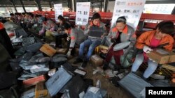 Employees sort packages at a hub of Shentong (STO) Express delivery company in Hefei, Anhui province. China's Singles' Day, which is celebrated annually on November 11, has become the world's largest online shopping day, with online shopping websites offe
