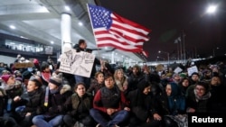 People gather to protest against the travel ban imposed by U.S. President Donald Trump's executive order, at O'Hare airport in Chicago, Illinois, Jan. 28, 2017.