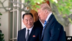 FILE - President Donald Trump talks with Kim Yong Chol, former North Korean military intelligence chief and one of leader Kim Jong Un's closest aides, as they walk from their meeting in the Oval Office of the White House in Washington, June 1, 2018.