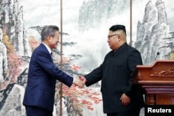 South Korean President Moon Jae-in shakes hands with North Korean leader Kim Jong Un after joint news conference in Pyongyang, North Korea, September 19, 2018.