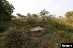 An open toilet is seen in a field in Gorba in the eastern Indian state of Chhattisgarh, India, Nov. 16, 2015.