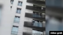 Video shows Mamoudou Gassama, 22, risking his life on Sunday as he climbed up the balconies to rescue the four-year-old who is clinging to a railing and glancing at the ground below, while horrified onlookers watched.