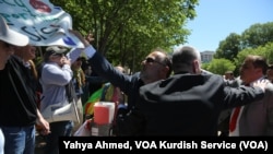 A pro-Turkey demonstrator tries to rip a sign from the hands of a pro-Kurdish demonstrator outside the White House, where U.S. President Donald Trump was hosting Turkish President Recep Tayyip Erdogan, May 16, 2017.