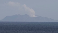 A plume of steam is seen above White Island early morning off the coast of Whakatane, New Zealand, Tuesday, Dec. 10, 2019. (AP Photo/Mark Baker)