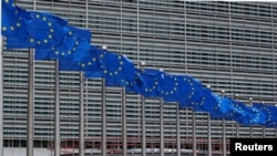 European Union flags flutter outside the European Commission headquarters in Brussels, Belgium, June 5, 2020. REUTERS/Yves Herman