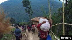 People displaced by fighting in north-western Myanmar between junta forces and anti-junta fighters walk in Chin State, Myanmar, May 31, 2021. Picture taken May 31, 2021. REUTERS/Stringer