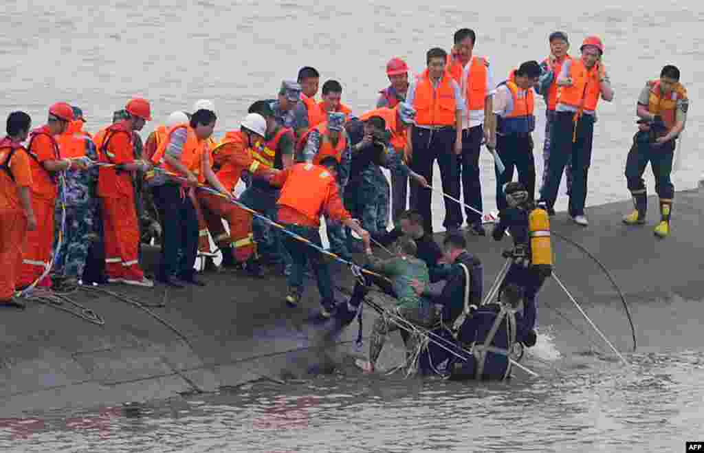 A 65-year-old woman is rescued by divers from the Dongfangzhixing or "Eastern Star" vessel which sank in the Yangtze river in Jianli, central China's Hubei province, June 2, 2015.