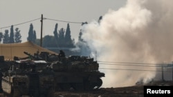 An Israeli soldier sits on top of a tank at a camp near the Israel-Gaza border, in Israel, Jan. 12, 2025. 