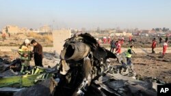 Debris is seen from an Ukrainian plane which crashed as authorities work at the scene in Shahedshahr, southwest of the capital Tehran, Iran, Jan. 8, 2020.