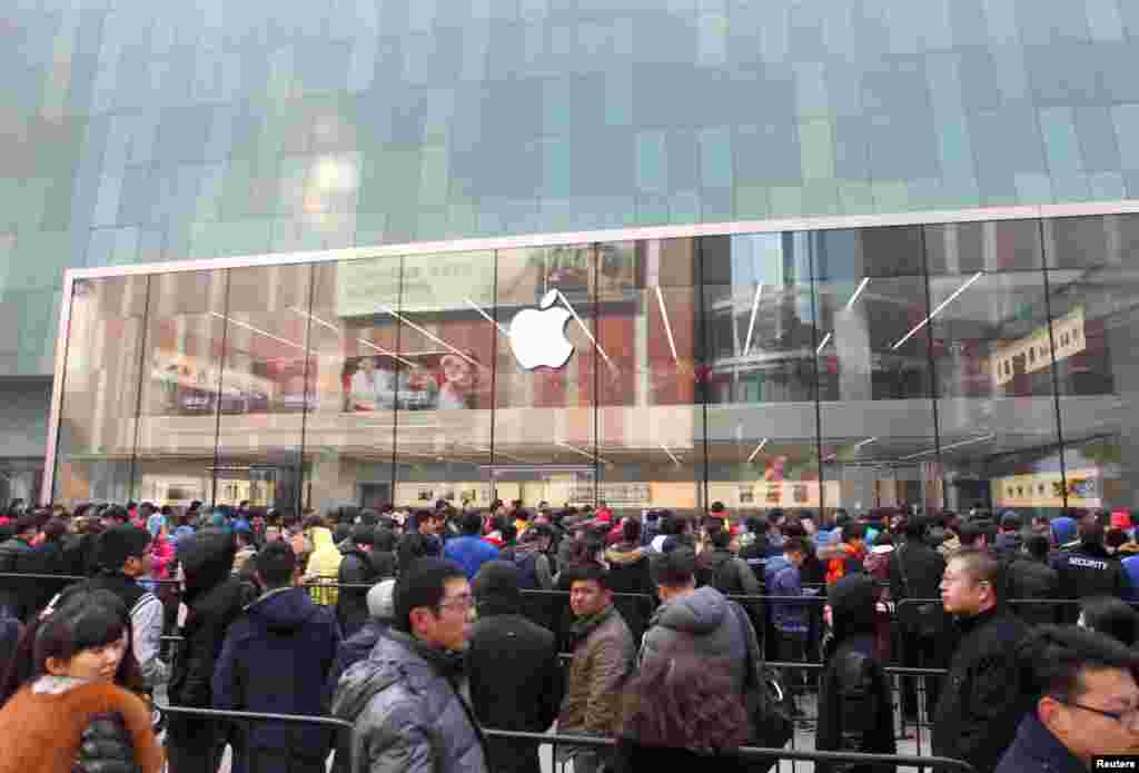 在沈阳的苹果专卖店外面,顾客等待商店开门(2015年2月28日)。