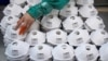 FILE PHOTO: Masks are seen on a production line manufacturing masks at a factory in Shanghai, China January 31, 2020. REUTERS/Aly Song/File Photo