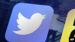 FILE -Twitter app on an iPhone screen in New York, Oct. 18, 2013.
