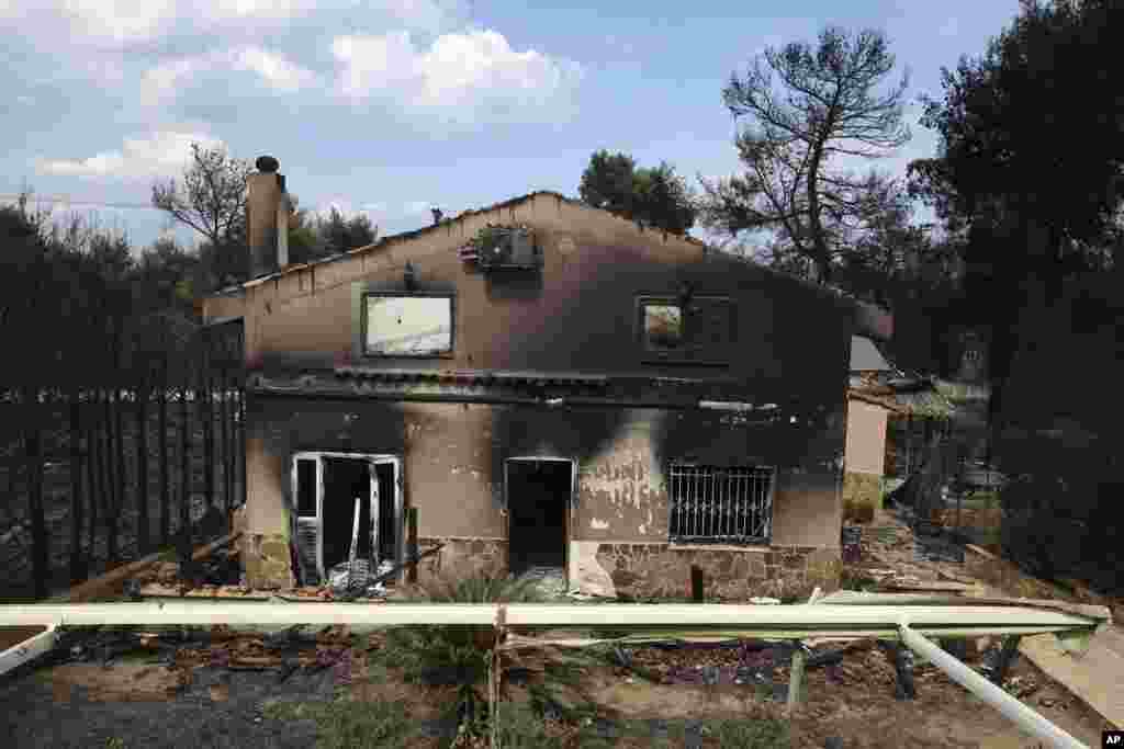 A burned house is seen in Agios Andreas, east of Athens, Tuesday, July 24, 2018.