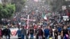 TOPSHOT - Migrants take part in a caravan towards the border with the United States in Tapachula, Chiapas State, Mexico, on Dec. 24, 2023.