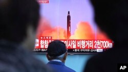 Warga Korsel menonton berita peluncuran rudal Korut dari sebuah layar lebar di stasiun kereta api di Seoul, Selasa (29/8). 