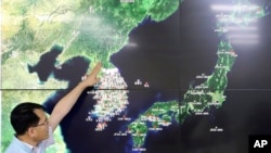 FILE - In this Sept. 3, 2017, file photo, Earthquake and Volcano of the Korea Monitoring Division Director Ryoo Yong-gyu speaks to the media about North Korea's artificial earthquake with a map of the Korean peninsular in Seoul, South Korea. (AP Photo/Lee Jin-man, File)