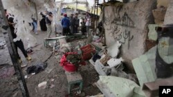 FILE - Citizens inspect the scene after a car bomb explosion at a crowded outdoor market in the Iraqi capital's eastern district of Sadr City, Iraq. UNAMI reported that 7,512 civilians were killed in Iraq in 2015. 