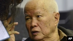 In this photo released by the Extraordinary Chambers in the Courts of Cambodia, Khieu Samphan, a former head of state for the Khmer Rouge, gestures as testimony is given during his trial at the U.N.-backed war crimes tribunal in Phnom Penh, file photo. 