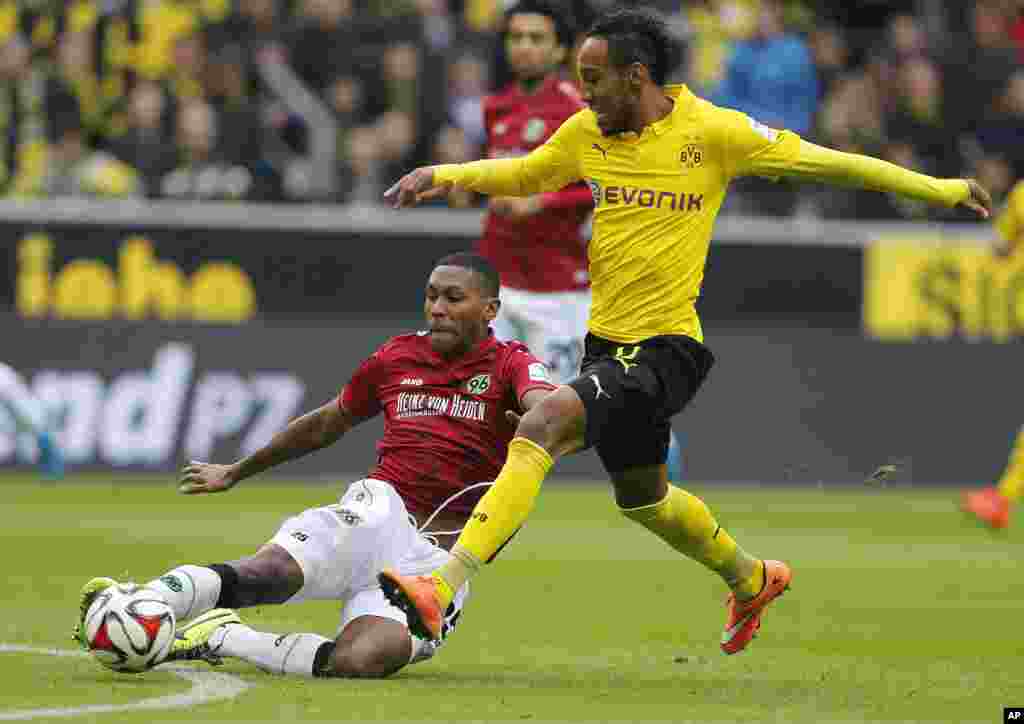 Pierre-Emerick Aubameyang du Dortmund, originaire du Gabon (à droite) se disputent un ballon avec Marcelo de Hanovre du Brésil (à gauche) lors du match de football de la première division de Bundesliga (Allemagne) entre le Borussia Dortmund et BvB Hannover 96 à Dortmund, Allemagne, le samedi 25 octobre 2014.