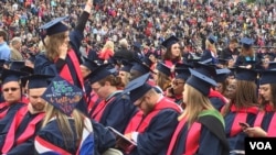 Some of the six thousand Liberty University graduates are seen in the school's football stadium for the Christian university's 44th commencement, in Lynchburg, Virginia, May 13, 2017. President Donald Trump will be speaking at the event. (C. Presutti/VOA)