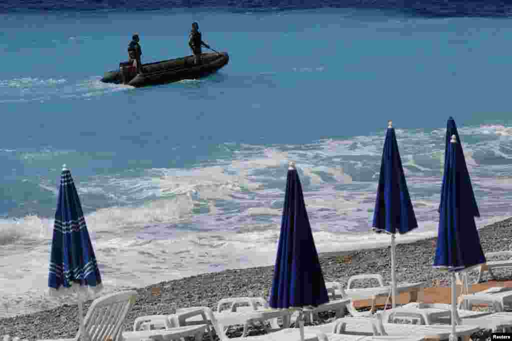 Armed soldiers patrol along the beach in Nice, France, July 15, 2016 the day after a truck ran into a crowd at high speed killing scores and injuring more who were celebrating the Bastille Day national holiday.