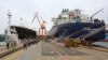 Workers walk past large-sized liquefied natural gas (LNG) carriers under construction at the Daewoo Shipbuilding and Marine Engineering facility in Geoje Island, South Korea, Dec. 7, 2018. 