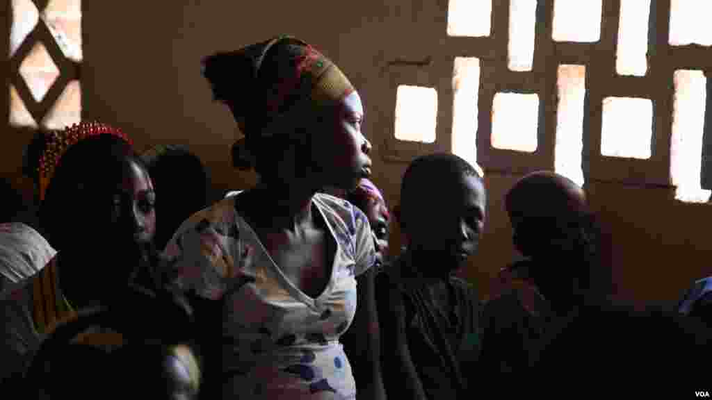 A girl stares out the window at Bossangoa chuch's Sunday prayers. Over 36,000 people are living at the site. (Hanna McNeish for VOA)