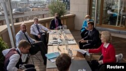 European Council President Charles Michel, German Chancellor A. Merkel, French President Macron and European Commission President Ursula von der Leyen meet on the sidelines of the first face-to-face EU summit in Brussels, July 18, 2020.