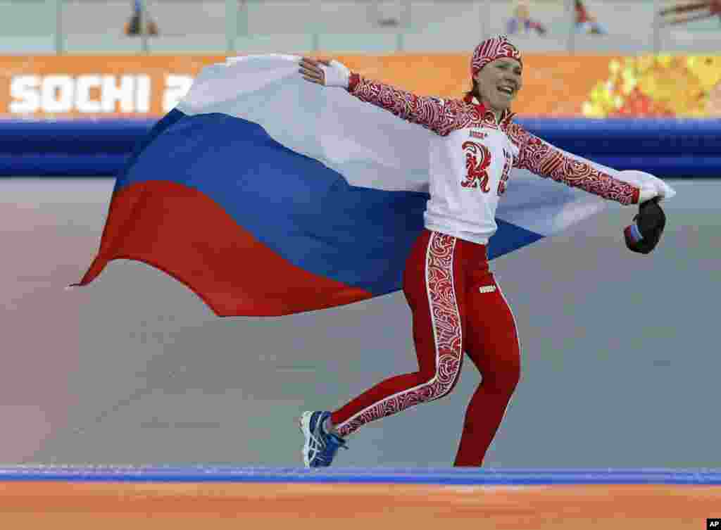 Russia's Olga Graf celebrates winning the bronze in the women's 3,000-meter speedskating race at the Adler Arena Skating Center, Sochi, Russia, Feb. 9, 2014.