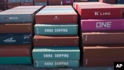 FILE - China Shipping Company containers are stacked at the Virginia International's terminal in Portsmouth, Virginia, May 10, 2019. 