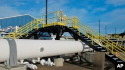 FILE - An above-ground section of Enbridge's Line 5 at the Mackinaw City, Michigan, pump station, Oct. 7, 2016.